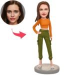 BH945jpg - printshop4me.ae Custom avatar model: cartoon woman in orange top and green cargo pants on a round base, with a circular inset photo to map a real face onto the avatar face.