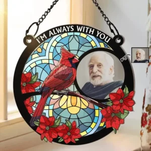 Round hanging memorial-style decorative plaque with stained-glass design featuring a red cardinal bird, red poinsettia flowers, and a circular photo insert of an elderly man. The top of the ornament reads “I’M ALWAYS WITH YOU,” and it is suspended by chains, symbolizing a remembrance or tribute keepsake.