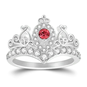 Elegant princess crown ring featuring a sparkling red center gemstone surrounded by brilliant clear crystals in a polished silver-tone band. Designed with intricate crown-inspired detailing, this royal-style statement ring makes a beautiful gift for women, girls, birthdays, anniversaries, Valentine's Day, Mother's Day, engagements, princess-themed celebrations, and special occasions. A timeless piece of fashion jewelry that adds sparkle and sophistication to any outfit.