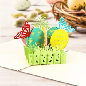 Easter eggs 3D pop-up greeting card featuring colorful decorative eggs, butterflies, spring grass, and floral accents. This handcrafted paper pop-up card opens to reveal a vibrant Easter scene, making it a charming keepsake and thoughtful greeting card for Easter celebrations, spring gifts, and seasonal décor.