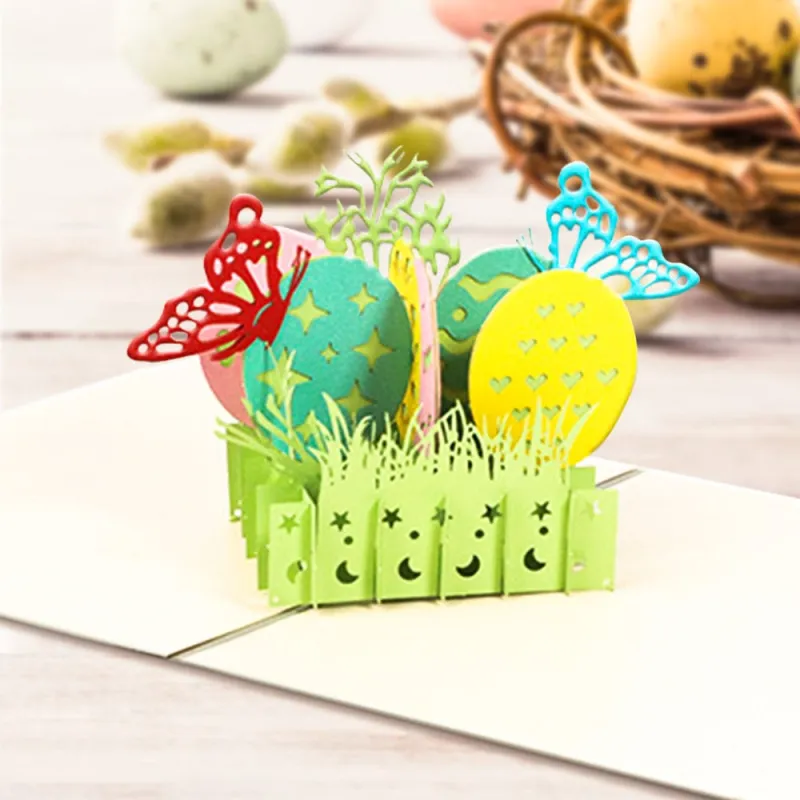 8bdcb49aff51265634bf890ee7ec3535webp - printshop4me.ae Easter eggs 3D pop-up greeting card featuring colorful decorative eggs, butterflies, spring grass, and floral accents. This handcrafted paper pop-up card opens to reveal a vibrant Easter scene, making it a charming keepsake and thoughtful greeting card for Easter celebrations, spring gifts, and seasonal décor.