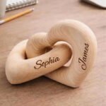 CBS0P2947X01jpg - printshop4me.ae Personalized wooden interlocking heart sculpture engraved with custom names, symbolizing love, connection, and togetherness. Crafted from natural solid wood with a smooth finish, this custom name heart décor makes a meaningful keepsake for couples, weddings, anniversaries, engagements, Valentine's Day, housewarmings, and romantic celebrations. A timeless decorative piece for desks, shelves, bedside tables, or home décor.