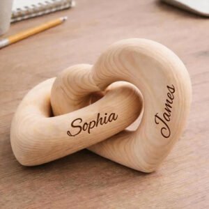 Personalized wooden interlocking heart sculpture engraved with custom names, symbolizing love, connection, and togetherness. Crafted from natural solid wood with a smooth finish, this custom name heart décor makes a meaningful keepsake for couples, weddings, anniversaries, engagements, Valentine's Day, housewarmings, and romantic celebrations. A timeless decorative piece for desks, shelves, bedside tables, or home décor.