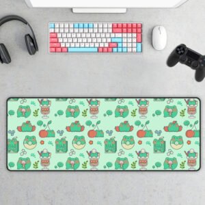 Cute kawaii green frog gaming desk mat featuring a seamless pattern of frogs, cherries, matcha drinks, lily pads, flowers, and playful illustrations. Displayed on a modern gaming desk with a pastel mechanical keyboard, mouse, headphones, and game controller, this extended mouse pad adds a fun aesthetic to any workspace.