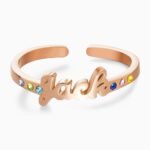 Personalized rose gold adjustable name ring featuring a custom script name with colorful birthstones set along the open band. A custom birthstone name ring designed as a meaningful gift for birthdays, anniversaries, Mother's Day, Valentine's Day, or everyday wear.