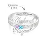 Personalized sterling silver couple name ring featuring two custom engraved names, sparkling cubic zirconia accents, and two heart-shaped birthstones. The inside of the band can be engraved with a custom message, making this elegant promise ring a meaningful gift for couples, anniversaries, weddings, Valentine's Day, birthdays, or special occasions.