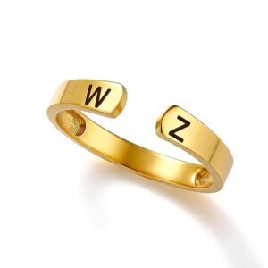 Gold open cuff ring with a polished finish, featuring engraved black initials “W” on one end and “Z” on the other. The adjustable ring has a minimalist curved design and is displayed on a clean white background.