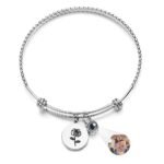 TYSS0P040X01jpg - printshop4me.ae Personalized projection bracelet with a silver twisted bangle design, featuring a rose charm and hidden photo projection bead that displays a custom image. An elegant keepsake bracelet for women, perfect as a personalized gift for anniversaries, Valentine's Day, birthdays, Mother's Day, or special occasions.