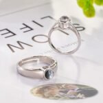 Personalized projection photo ring in polished silver featuring a hidden custom photo gemstone that projects a cherished image. The adjustable ring showcases a sleek minimalist design with a round projection stone, making it a meaningful keepsake gift for couples, anniversaries, weddings, Valentine's Day, birthdays, and special occasions.