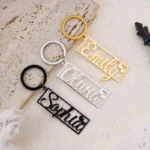 bddac9b5833d59e1fb0f1c821fd4fb7bwebp - printshop4me.ae Set of three personalized name keychains in gold, silver, and black finishes, featuring custom-cut names with heart accents in a modern rectangular design. Stylish metal keyrings displayed on a textured surface, ideal as personalized gifts for birthdays, couples, friends, family, or everyday use.