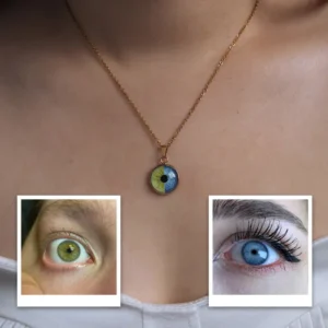 Gold chain necklace worn on a person’s neck featuring a round pendant designed like an eye with a multicolored iris (green and blue tones). At the bottom of the image, two reference photos show close-up human eyes—one green and one blue—demonstrating the customization inspiration for the pendant design.