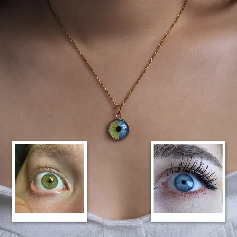c22ce8c50aba4343bcf0fe8297c3bc00webp - printshop4me.ae Gold chain necklace worn on a person’s neck featuring a round pendant designed like an eye with a multicolored iris (green and blue tones). At the bottom of the image, two reference photos show close-up human eyes—one green and one blue—demonstrating the customization inspiration for the pendant design.