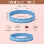 Blue Argentina silicone wristband showing the size dimensions (6.5 cm diameter, 1.2 cm thickness), labeled as waterproof, colorfast, soft, and safe for use. Two bracelets displayed, one flat and one standing.